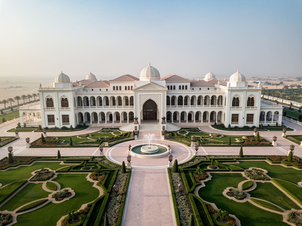 Aerial view of the grand white Qasr Al Watan palace and formal gardens